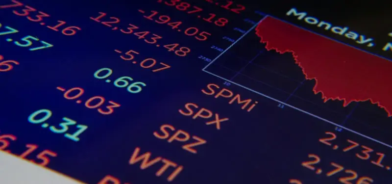 A sophisticated financial dashboard display featuring real-time stock ticker symbols and performance charts, representing the React-driven data visualization engine engineered by Seismic Pixels for MoneyFlows.