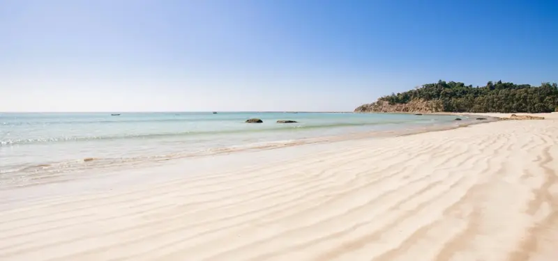 A scenic tropical beach at sunset, representing the coastal and vacation-themed giftware market served by the enterprise Magento 2 wholesale platform engineered by Seismic Pixels for Cape Shore.